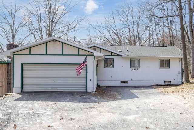 ranch-style home featuring crawl space, driveway, and roof with shingles