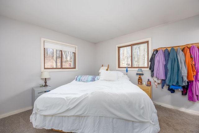 carpeted bedroom featuring baseboards