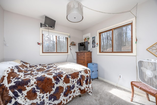 carpeted bedroom featuring baseboards