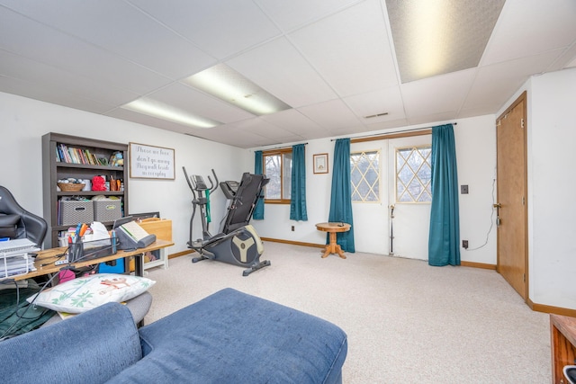 exercise room with a drop ceiling, baseboards, visible vents, and carpet flooring