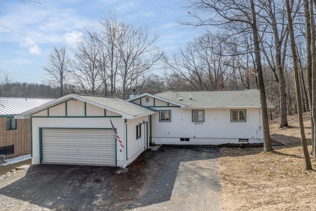 ranch-style home with crawl space, driveway, a garage, and roof with shingles