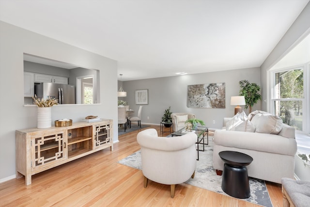 living room featuring baseboards and light wood-style flooring