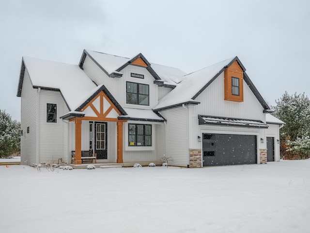 modern farmhouse with a standing seam roof, an attached garage, and metal roof