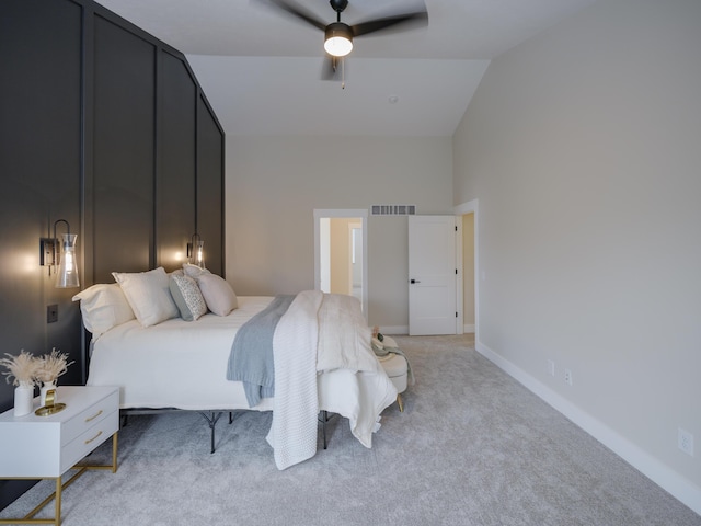 bedroom featuring visible vents, baseboards, light carpet, high vaulted ceiling, and a ceiling fan