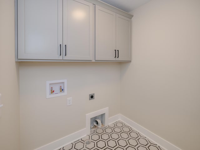 laundry room with electric dryer hookup, baseboards, cabinet space, and hookup for a washing machine