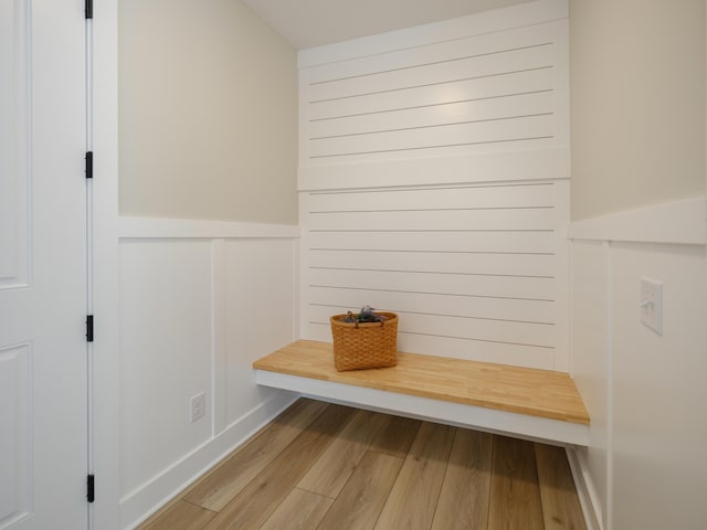 mudroom with a wainscoted wall and light wood-style flooring