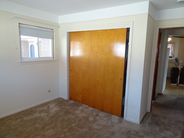 unfurnished bedroom featuring a closet and carpet