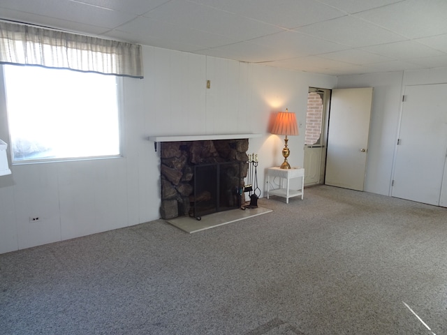 unfurnished living room with carpet and a fireplace