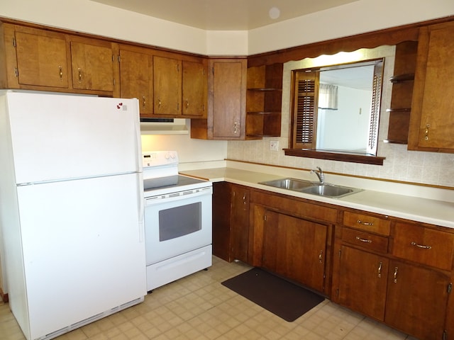 kitchen with open shelves, light floors, white appliances, and a sink