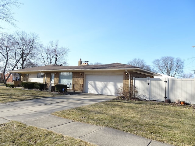 ranch-style home featuring a gate, driveway, an attached garage, a chimney, and brick siding