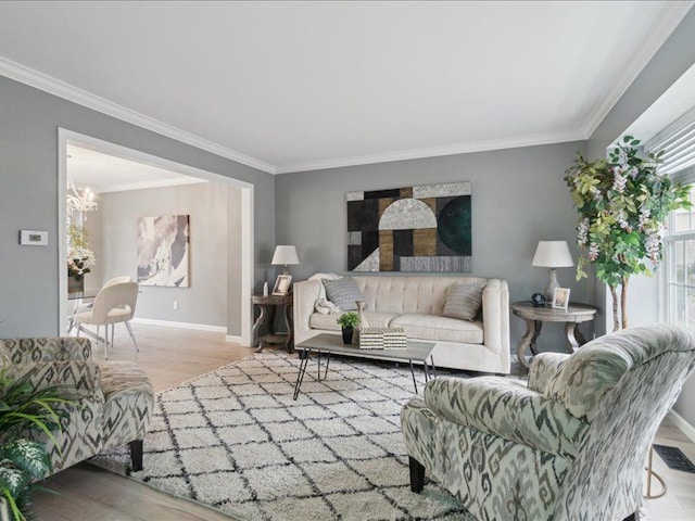 living room with visible vents, baseboards, wood finished floors, and crown molding