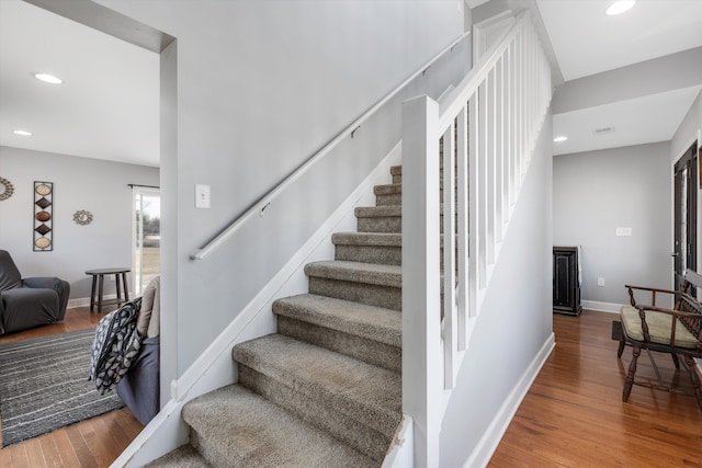 staircase featuring visible vents, recessed lighting, wood finished floors, and baseboards