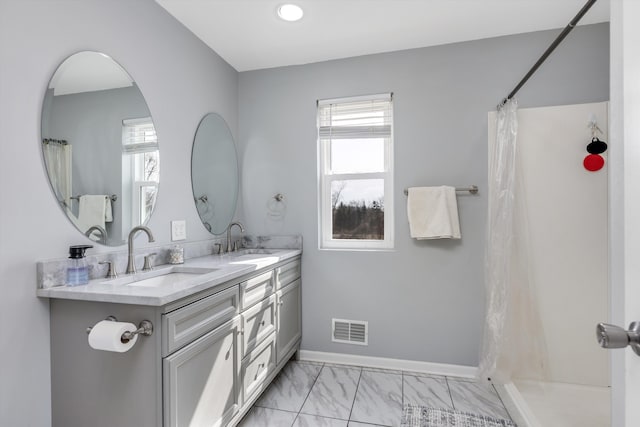 full bath featuring a sink, visible vents, and plenty of natural light