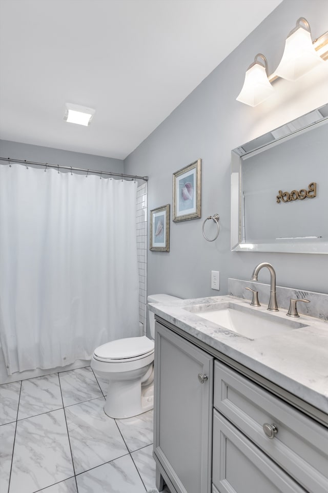 bathroom with curtained shower, toilet, marble finish floor, and vanity