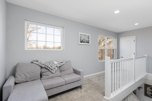 carpeted living room with recessed lighting and baseboards