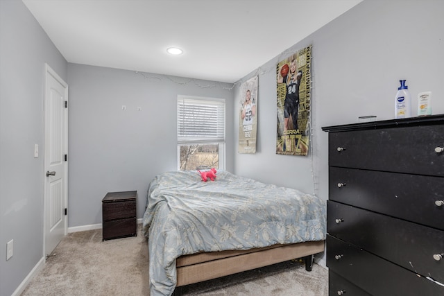 bedroom with light carpet and baseboards