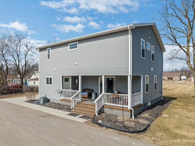 view of front of property with covered porch and central AC