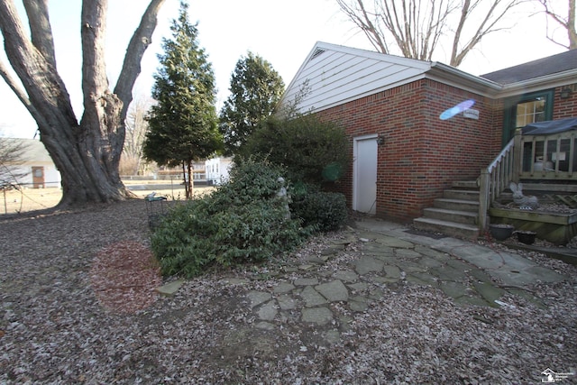 view of property exterior with brick siding