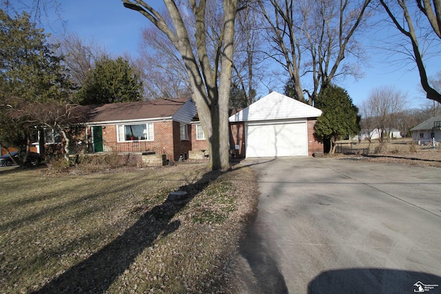 single story home featuring concrete driveway, a garage, brick siding, and a front yard