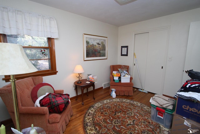 sitting room featuring visible vents and wood finished floors