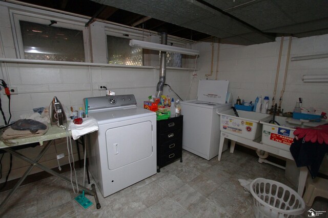 laundry area with washing machine and clothes dryer and laundry area