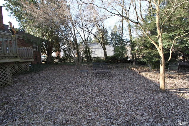 view of yard featuring a wooden deck