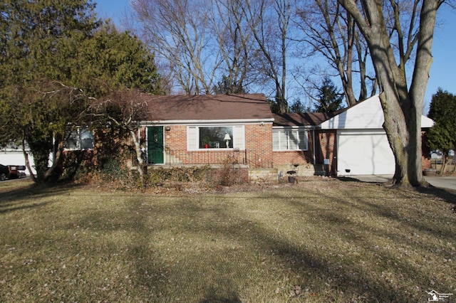 ranch-style house with brick siding, an attached garage, and a front yard