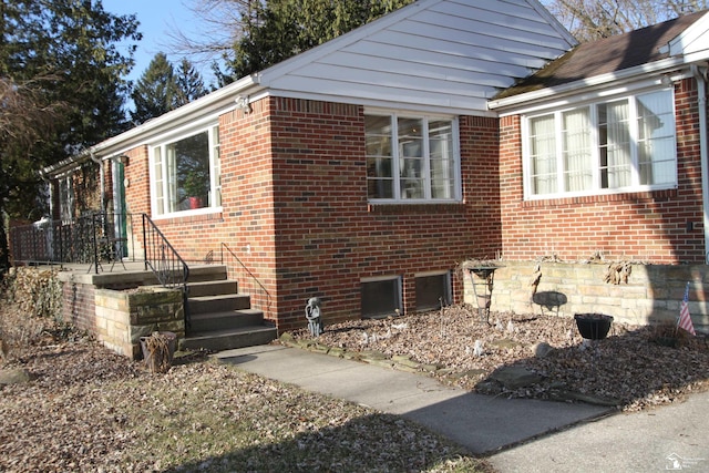 view of side of home featuring brick siding