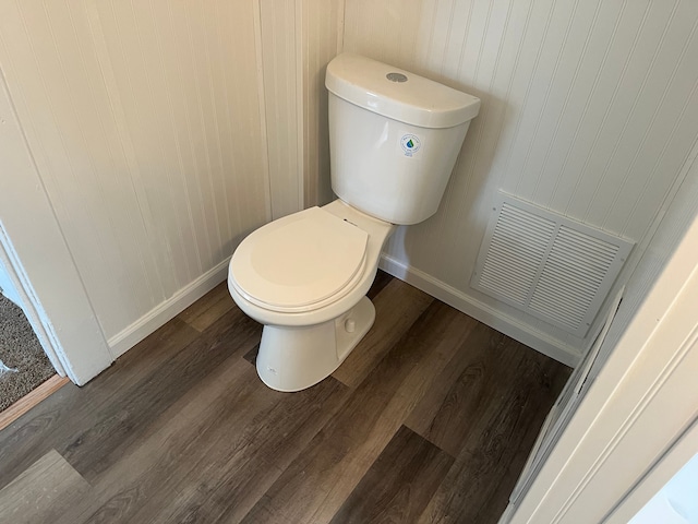 bathroom featuring visible vents, toilet, baseboards, and wood finished floors