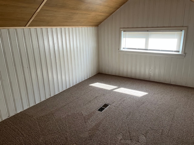 additional living space featuring wooden ceiling, visible vents, carpet floors, and vaulted ceiling