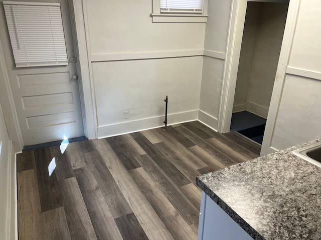 interior space with dark wood-style floors and baseboards