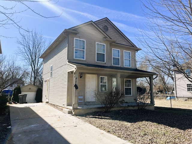 view of front of property featuring a porch, concrete driveway, an outdoor structure, and fence