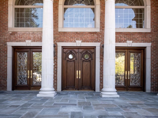 doorway to property with french doors and brick siding