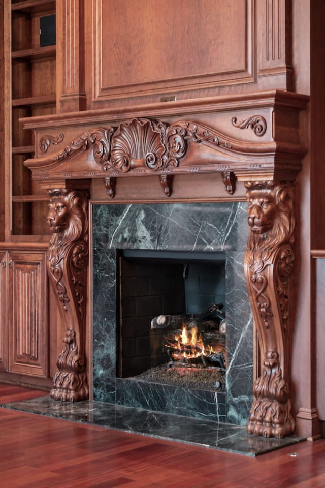 room details featuring a high end fireplace and wood finished floors