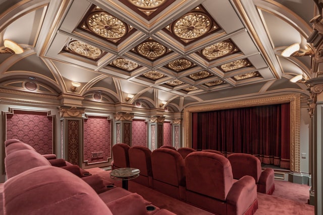 carpeted cinema room featuring wallpapered walls, decorative columns, and coffered ceiling