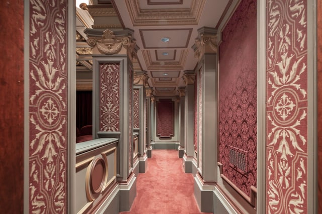hallway with carpet, crown molding, and coffered ceiling