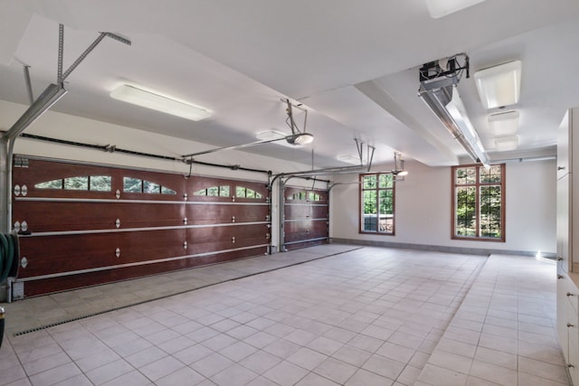 garage featuring a garage door opener and baseboards
