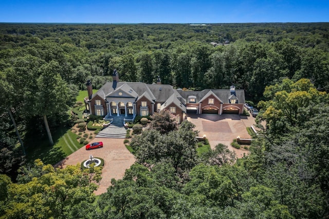 drone / aerial view featuring a wooded view