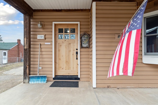 view of exterior entry with fence