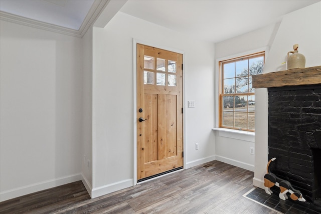 entryway featuring ornamental molding, baseboards, and wood finished floors