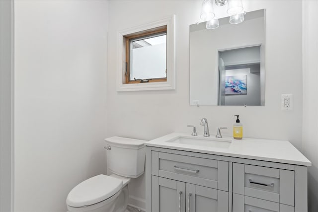 half bathroom featuring toilet and vanity