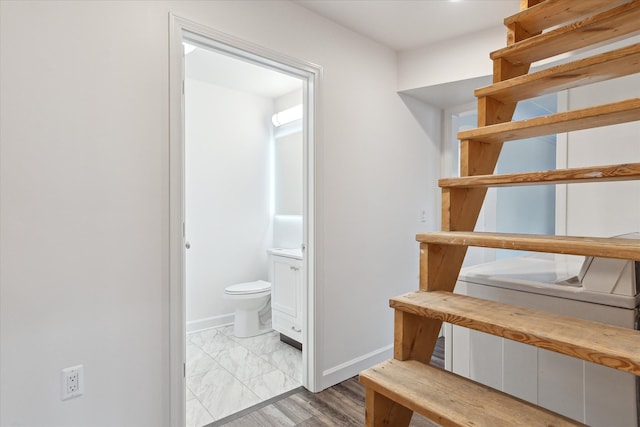 interior space with baseboards and marble finish floor