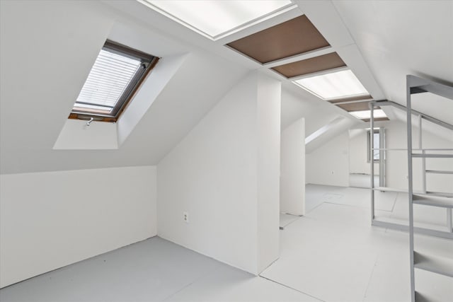 bonus room featuring lofted ceiling with skylight