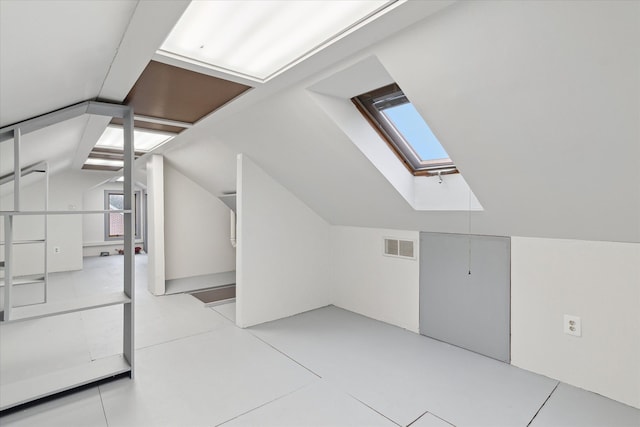 bonus room featuring visible vents and vaulted ceiling with skylight