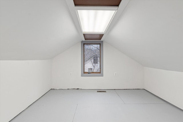 additional living space with lofted ceiling and visible vents