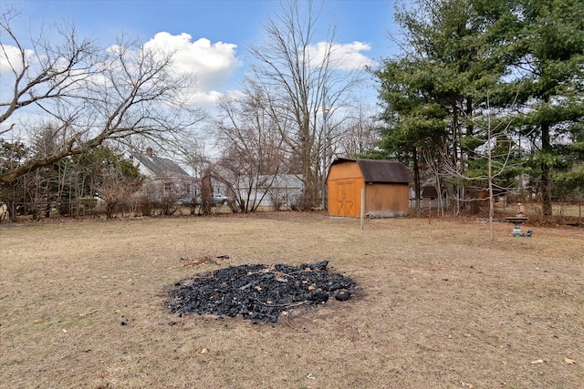 view of yard with a storage shed, fence, and an outdoor structure