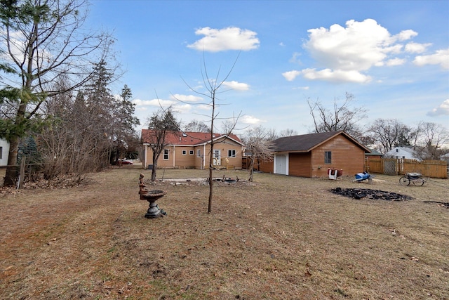 exterior space featuring an outbuilding and fence