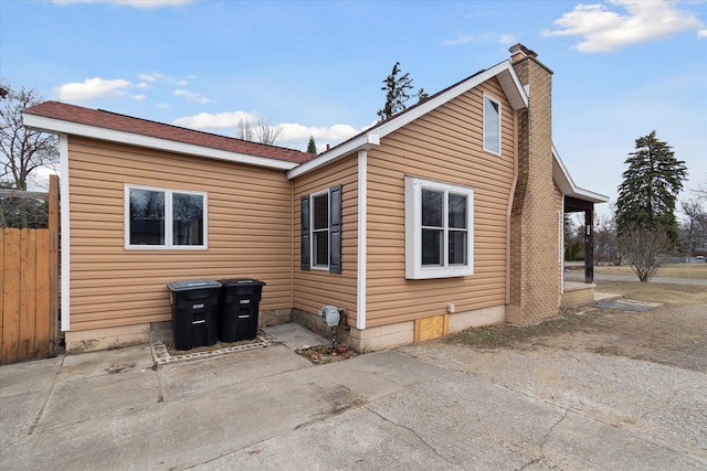 exterior space featuring a chimney, a patio, and fence