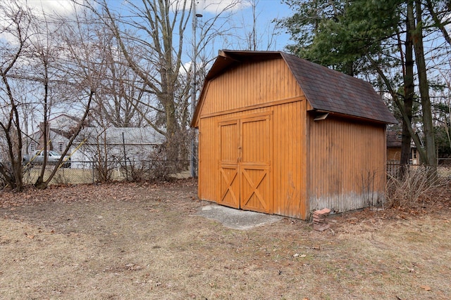 view of shed featuring fence