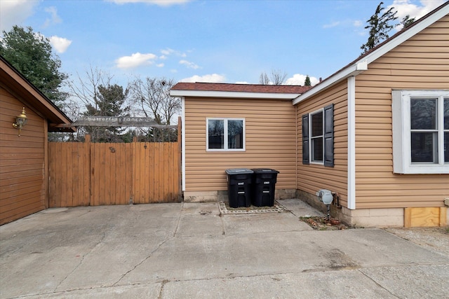 view of side of home with a patio area and fence